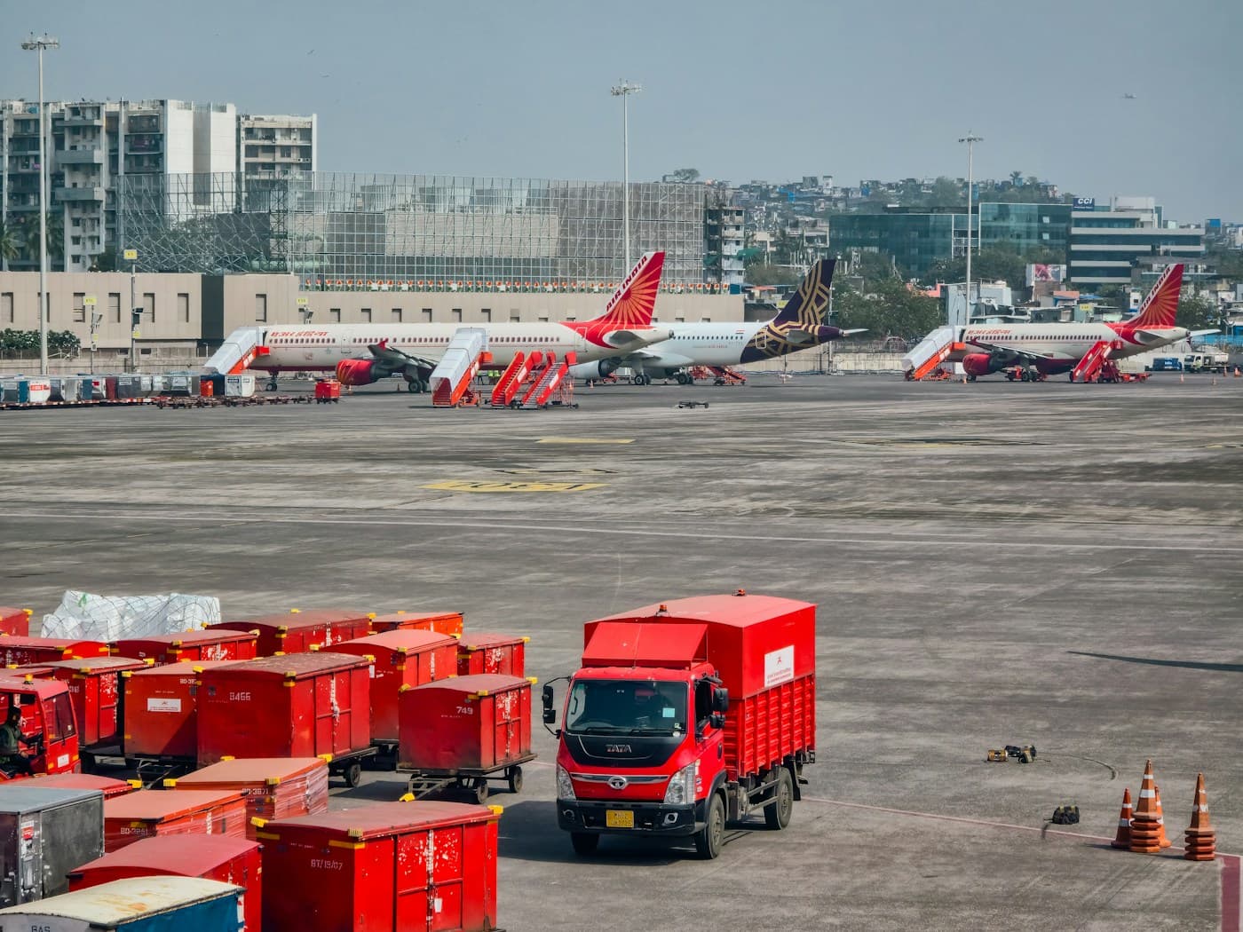 Airport ground handling operations with cargo vehicles and aircraft on the tarmac